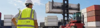 SILVERSEA Containers specialist overseeing the handling of an industrial cargo container with a reach stacker.