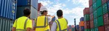 Team inspecting shipping containers in a yard while assessing suitable dry van units for storage or cargo use.