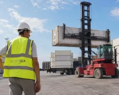 SILVERSEA Containers specialist overseeing the handling of an industrial cargo container with a reach stacker.