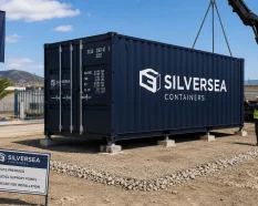 Shipping container installed on light support points on a prepared site in Spain without permanent foundations